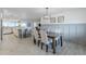 Open concept dining room with wood table and modern chandelier next to bright, updated kitchen at 10844 N 37Th St, Phoenix, AZ 85028