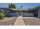A charming single-story home's entryway features a cute, gated walkway at 10844 N 37Th St, Phoenix, AZ 85028
