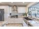 Beautiful kitchen with white cabinets, stainless steel appliances, granite counters, and a farmhouse sink at 10844 N 37Th St, Phoenix, AZ 85028