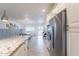 Open-concept kitchen with stainless steel appliances, granite counters, and a view of the dining area at 10844 N 37Th St, Phoenix, AZ 85028