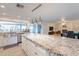 Bright kitchen features a large island with granite countertops and an open view of the spacious living room at 10844 N 37Th St, Phoenix, AZ 85028