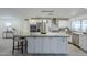 Bright kitchen features white cabinets, stainless steel appliances, granite countertops and a large island at 10844 N 37Th St, Phoenix, AZ 85028