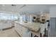 Open floor plan kitchen featuring a large island with barstool seating and bright lighting at 10844 N 37Th St, Phoenix, AZ 85028