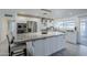 Bright kitchen features white cabinets, stainless steel appliances, granite countertops and a large island at 10844 N 37Th St, Phoenix, AZ 85028