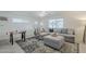 Cozy living room with plush sectional sofa, stylish rug, and ample natural light at 10844 N 37Th St, Phoenix, AZ 85028
