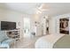 Bright main bedroom featuring a ceiling fan, dresser and ensuite bathroom at 10844 N 37Th St, Phoenix, AZ 85028