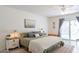 Cozy main bedroom with a ceiling fan, sliding glass door, and neutral decor at 10844 N 37Th St, Phoenix, AZ 85028