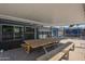 Covered patio with a large wooden picnic table, ideal for outdoor dining and entertaining guests at 10844 N 37Th St, Phoenix, AZ 85028