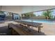 Covered patio with a large wooden picnic table overlooking the pool, ideal for outdoor dining at 10844 N 37Th St, Phoenix, AZ 85028