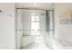 Modern shower with glass enclosure, rainfall showerhead, and bench seating at 10844 N 37Th St, Phoenix, AZ 85028