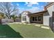 The backyard is a haven with grass, a patio, and an outdoor dining area at 11141 E North Ln, Scottsdale, AZ 85259