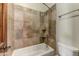 This cozy bathroom is finished with stone-look tile and features a shower over the tub at 11141 E North Ln, Scottsdale, AZ 85259