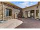 Private courtyard featuring stone walls, brick pavers, an ornate fountain and multiple windows at 11141 E North Ln, Scottsdale, AZ 85259