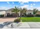 Charming single-story home featuring a well-manicured lawn, desert landscaping, and a three-car garage at 11141 E North Ln, Scottsdale, AZ 85259