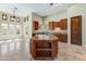 Open-concept kitchen with a center island, granite countertops, tile flooring and abundant natural light at 11141 E North Ln, Scottsdale, AZ 85259
