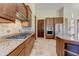 Well-equipped kitchen featuring a gas cooktop, granite countertops, tile backsplash and stainless steel appliances at 11141 E North Ln, Scottsdale, AZ 85259