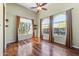 The living room features hardwood floors, three windows, and custom curtains and blinds at 11141 E North Ln, Scottsdale, AZ 85259