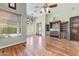 Open living room with wood floors and built-in shelving units at 11141 E North Ln, Scottsdale, AZ 85259