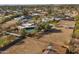 Wide-angle aerial showcasing pool, horse arena, and home with solar panels at 11823 N 76Th Way, Scottsdale, AZ 85260