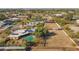 Wide-angle aerial showcasing pool, horse arena, and home with solar panels at 11823 N 76Th Way, Scottsdale, AZ 85260