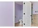 View of toilet and shower in bathroom with lavender colored walls at 11823 N 76Th Way, Scottsdale, AZ 85260