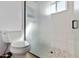 Bathroom with glass-enclosed shower, toilet, and marble floors at 11823 N 76Th Way, Scottsdale, AZ 85260