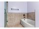 Bathroom featuring a tiled bathtub and shower combination with glass door at 11823 N 76Th Way, Scottsdale, AZ 85260
