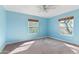 Bright bedroom features carpet, ceiling fan, and natural light from two windows at 11823 N 76Th Way, Scottsdale, AZ 85260