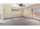 Bright bedroom features carpet, ceiling fan and access to the outside through glass paneled doors at 11823 N 76Th Way, Scottsdale, AZ 85260
