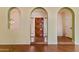 Elegant entryway with wood door and arched openings, showcasing the home's unique architectural details at 11823 N 76Th Way, Scottsdale, AZ 85260