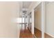 Hallway with laminate flooring, mirrored closet, and white trim at 11823 N 76Th Way, Scottsdale, AZ 85260