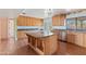 Bright kitchen with light wood cabinets, granite counters, a center island, and stainless steel appliances at 11823 N 76Th Way, Scottsdale, AZ 85260