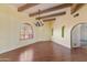 Bright living room with arched window, wood floors, and decorative green inset niches at 11823 N 76Th Way, Scottsdale, AZ 85260
