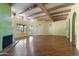 Large bright living room with exposed beam ceiling and wood floor overlooking the green backyard at 11823 N 76Th Way, Scottsdale, AZ 85260