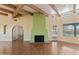 Open living space features a green fireplace, wood beam ceiling, and access to the backyard pool at 11823 N 76Th Way, Scottsdale, AZ 85260
