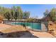 Private pool area with mature trees, secured by a protective safety fence at 11823 N 76Th Way, Scottsdale, AZ 85260