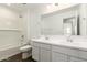 Bright bathroom featuring a double vanity, a soaking tub, and white subway tile surround at 12373 W Marguerite Ave, Avondale, AZ 85323