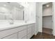Bright bathroom featuring a double sink vanity, large mirror, and an adjacent walk-in closet at 12373 W Marguerite Ave, Avondale, AZ 85323