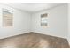 This cozy bedroom has wood-look tile flooring and windows overlooking neighborhood homes at 12373 W Marguerite Ave, Avondale, AZ 85323