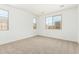 Bright, carpeted bedroom featuring large windows, neutral paint, and lots of natural light at 12373 W Marguerite Ave, Avondale, AZ 85323