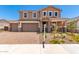 Charming two-story home with a brick driveway, three-car garage, and beautiful landscaping at 12373 W Marguerite Ave, Avondale, AZ 85323