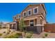 Two-story home featuring a brick and stucco exterior, a paved driveway, and desert landscaping at 12373 W Marguerite Ave, Avondale, AZ 85323