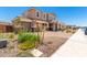 Inviting two-story home showcases a three-car garage, vibrant landscaping, and a welcoming facade in a pleasant community at 12373 W Marguerite Ave, Avondale, AZ 85323