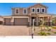 Attractive two-story home featuring a two-car garage, decorative stone accents, and a covered entry at 12373 W Marguerite Ave, Avondale, AZ 85323