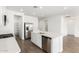 Modern kitchen featuring white cabinets, stainless steel appliances, and an island with a sink at 12373 W Marguerite Ave, Avondale, AZ 85323
