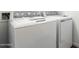 Close-up of a white GE washing machine and dryer set with a utility sink at 12373 W Marguerite Ave, Avondale, AZ 85323