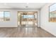 Bright living room area with wood-look tile flooring and large sliding glass doors at 12373 W Marguerite Ave, Avondale, AZ 85323