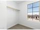 Walk-in closet with carpet flooring, a built-in shelf, and a window showing community homes at 12373 W Marguerite Ave, Avondale, AZ 85323