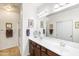 Bathroom with dual sinks, clean white countertops, and a large mirror and shower stall at 1475 N Agave St, Casa Grande, AZ 85122