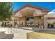Clubhouse exterior with stone accents and a spacious entrance, surrounded by manicured landscaping and bike racks at 1475 N Agave St, Casa Grande, AZ 85122
